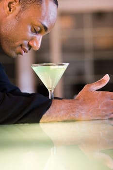 Side profile of a businessman with a glass of martini