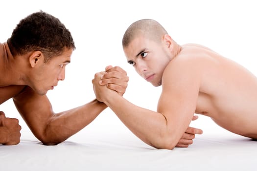 Side profile of two young men arm wrestling