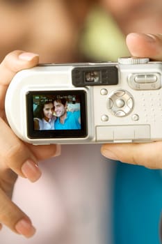 Mid adult man and a young woman taking a photograph of themselves