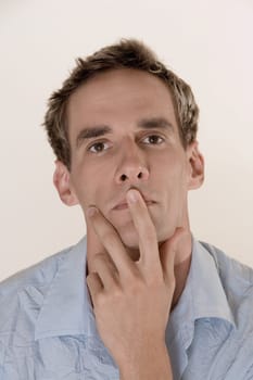 Portrait of a young man with his finger on his lips