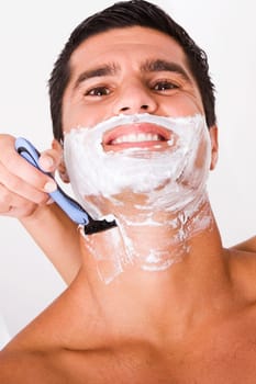 Close-up of a womanŽs hand shaving a mid adult man