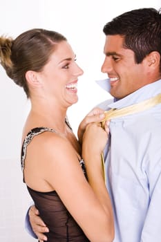Side profile of a young woman pulling a mid adult manŽs tie