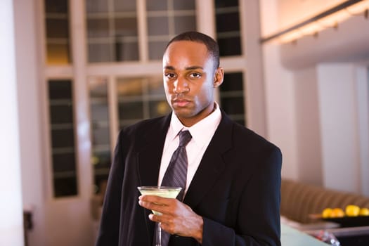 Portrait of a businessman holding a glass of martini
