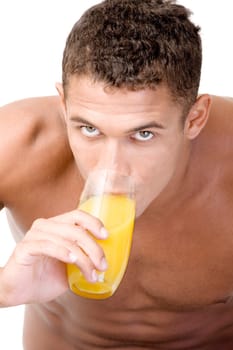 Portrait of a young man drinking a glass of juice