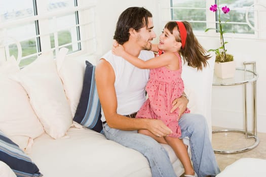 Side profile of a father hugging his daughter