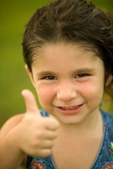 Portrait of a girl making a thumbs up sign