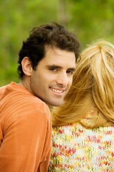 Portrait of a mid adult man sitting with a young woman