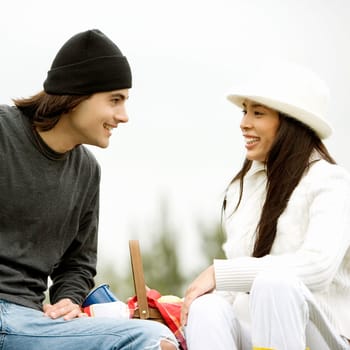 Close-up of a young couple sitting and smiling