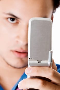 Portrait of a young man holding a mobile phone