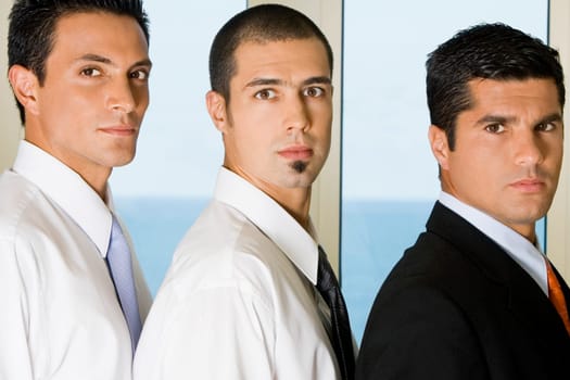 Side profile of three businessmen standing in a row