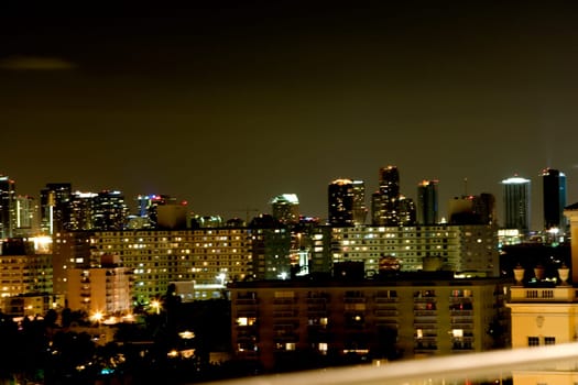 High angle view of buildings lit up at night