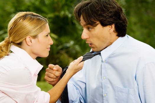 Side profile of a businesswoman holding a businessmanŽs tie