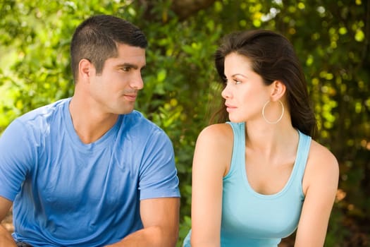 Close-up of a young woman and a mid adult man looking at each other