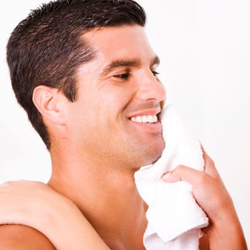 Close-up of a womanŽs hand wiping a mid adult manŽs face with a towel
