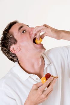 Close-up of a mid adult man eating a fruit tart
