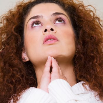 Low angle view of a young woman looking up