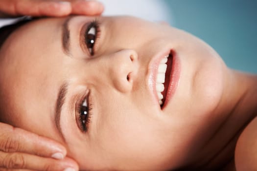 Portrait of a young woman getting a head massage