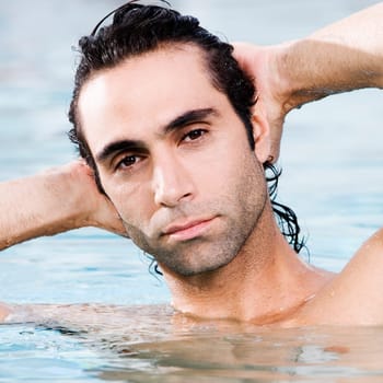 Portrait of a mid adult man swimming in a swimming pool