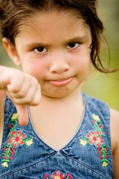 Portrait of a girl showing thumbs down