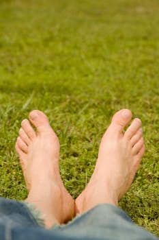 Low section view of a personŽs feet on the grass