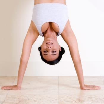 Portrait of a young woman standing on her hands