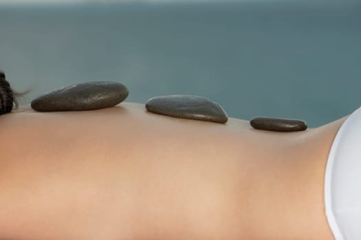 Mid section view of a woman getting lastone therapy