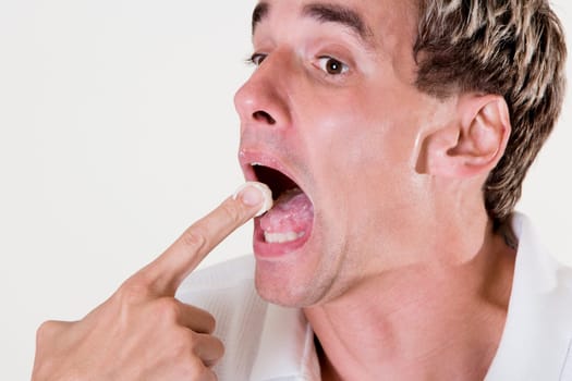 Side profile of a mid adult man eating a fruit tart