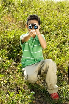 Boy looking through a pair of binoculars