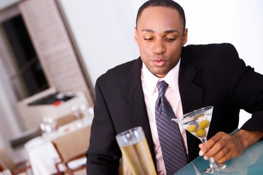 Close-up of a businessman holding a glass of martini