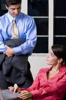 Businessman and a businesswoman looking at each other