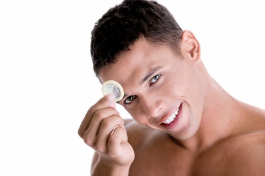 Portrait of a young man holding a condom