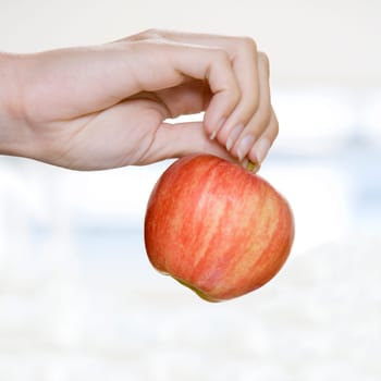 WomanŽs hand holding an apple