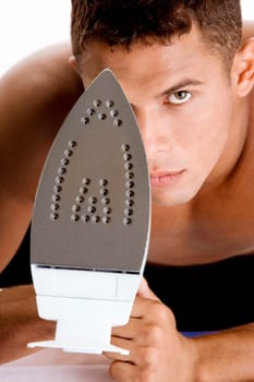 Portrait of a young man holding an iron