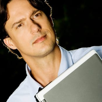 Close-up of a businessman holding a laptop