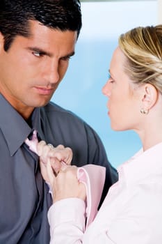Close-up of a businesswoman adjusting a businessmanŽs tie