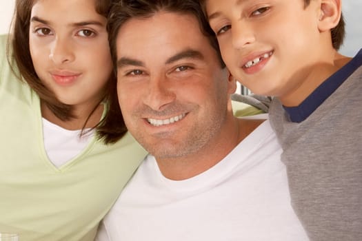Portrait of a father with his son and his daughter smiling
