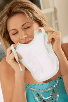 Close-up of a mid adult woman holding a baby bib