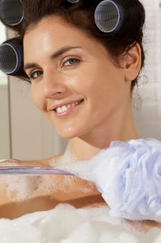 Portrait of a young woman in a bubble bath