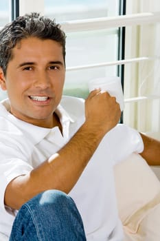 Portrait of a mid adult man holding a cup