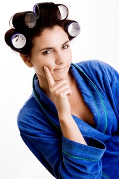 Portrait of a young woman with curlers in her hair