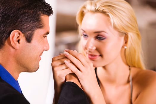 Close-up of a mid adult man and a young woman holding hands