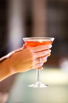 Close-up of a young womanŽs hand holding a glass of martini