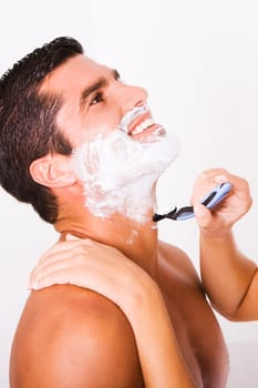Close-up of a womanŽs hand shaving a mid adult man