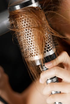 Close-up of a womanŽs hand brushing her hair