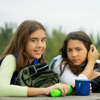 Portrait of a girl and her friend holding a mug