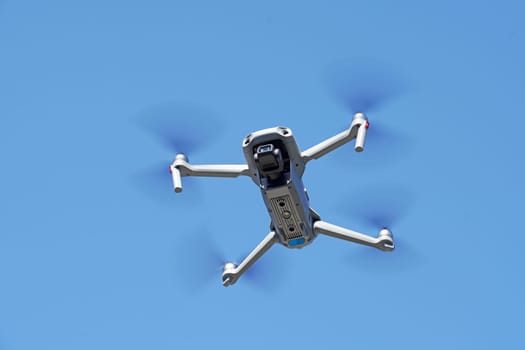 drone flying in air and clear blue sky background