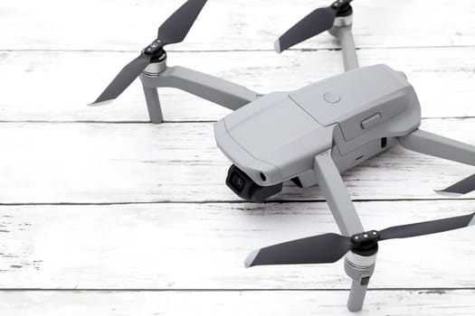 small drone copter on wooden white table. Close-up