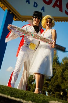 Mid adult man and a mid adult woman dressed in costumes, Las Vegas, Nevada, USA