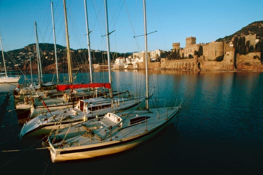 Sailboats at La Napoule Harbor near a castle, CotepŽAzur, France