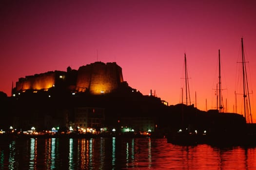 Scenic view of a fortress and a harbor at night, Bonifacio, Corsica, France
